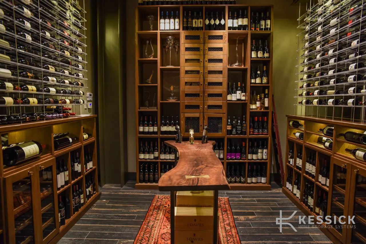 A timber wine room with a live-edge tasting table on a runner, racks rising to the ceiling.