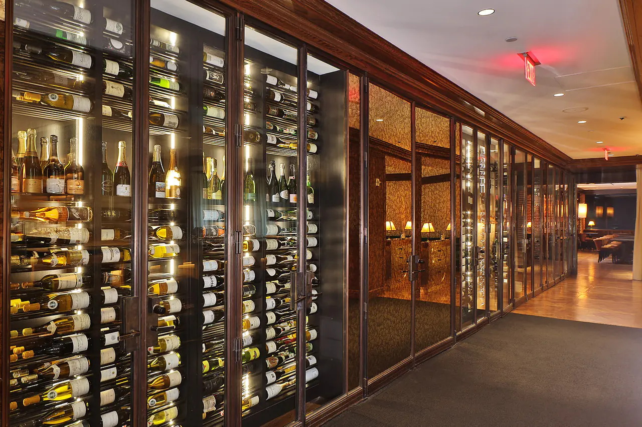 A glass wall of wine running the length of a corridor.