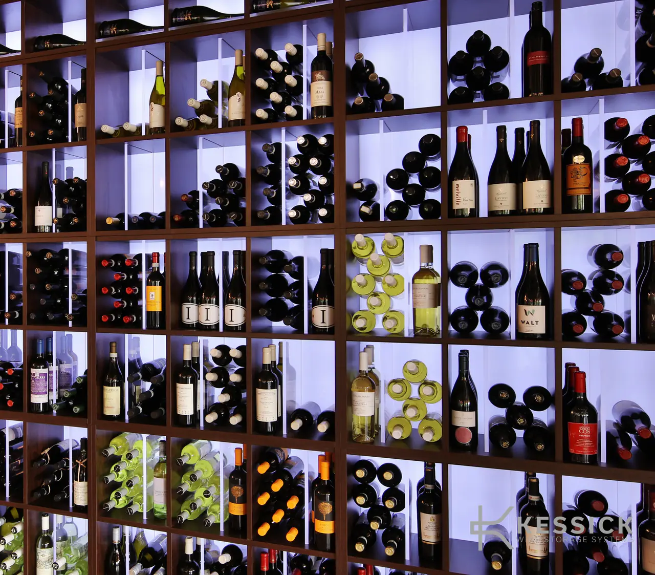 Backlit cubbies of wine, seen at an angle.