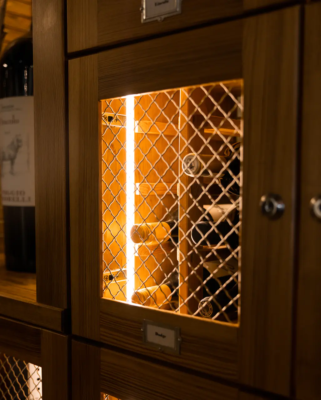 A single timber locker door with lattice, lit from inside.
