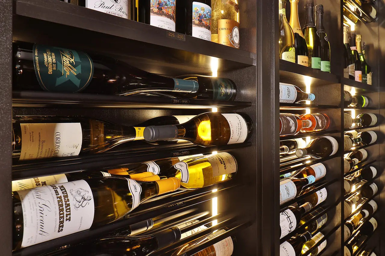 White wine on dark rods, lit from the side, close up.