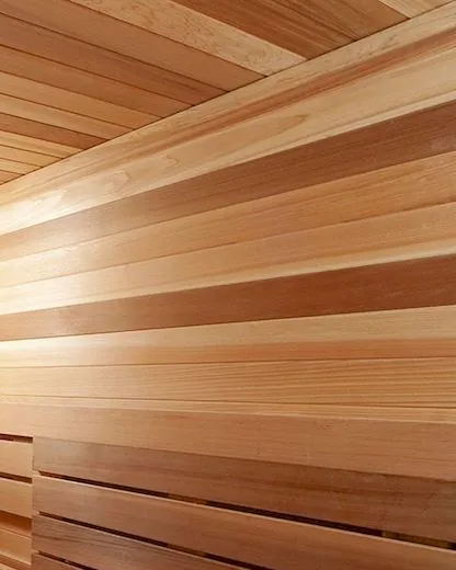 Close view of timber wall boards, their grain running from pale gold to reddish brown.